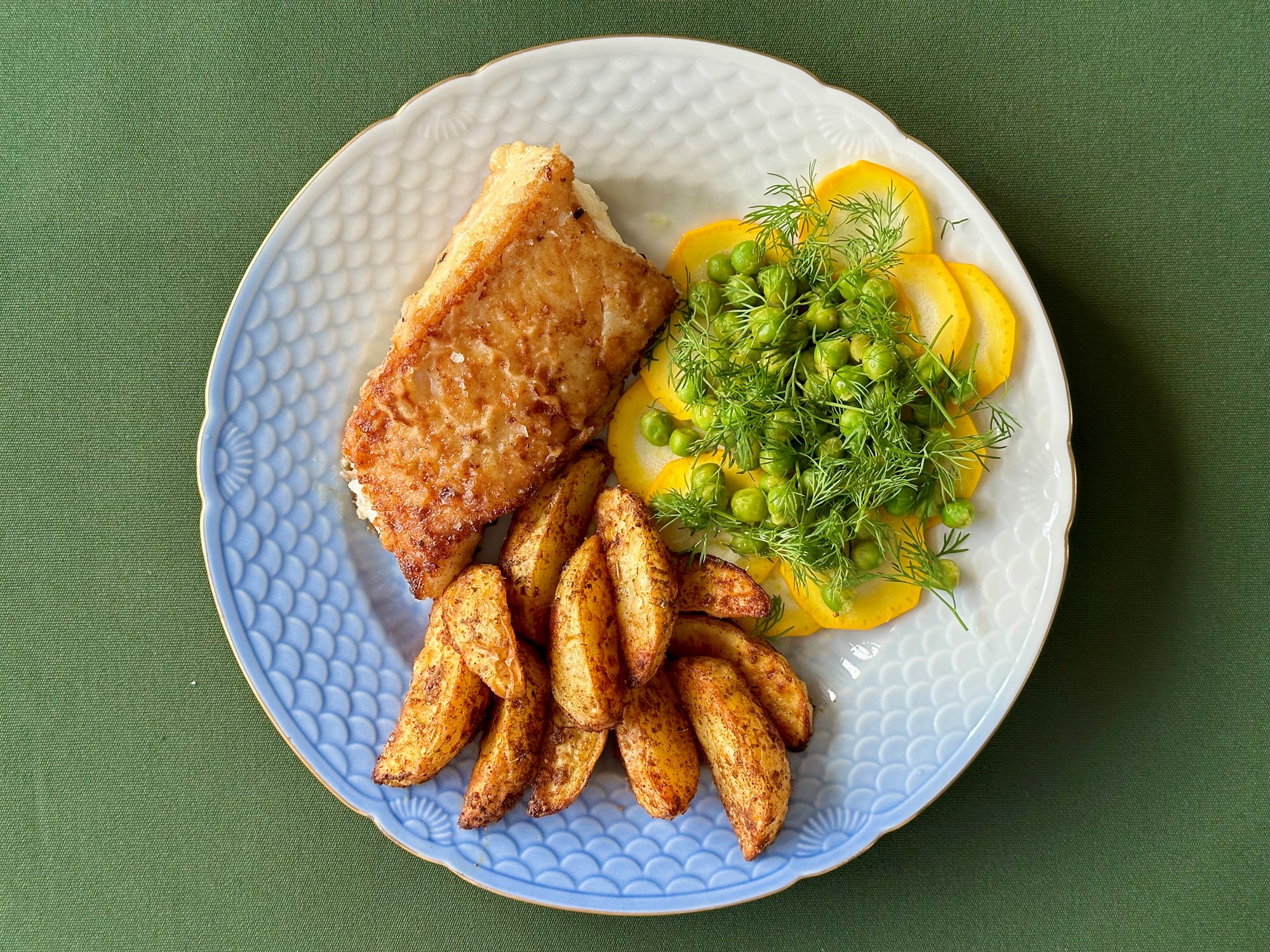 Paneret torsk i salat på grønne ærter, squash og dild