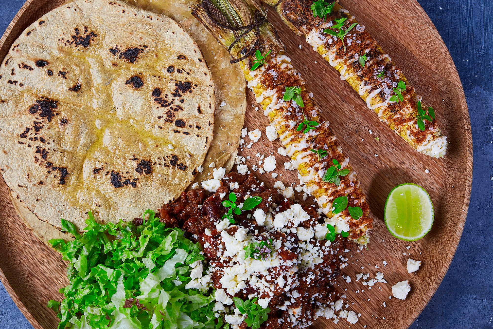 Mexikansk majs Elote med queso fresco & frisk oregano, dertil sprøde tlayuda tortillas med krydret okse og chilibeans